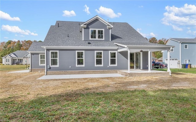 back of property featuring a patio area and a yard