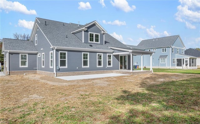 back of house featuring a patio and a yard