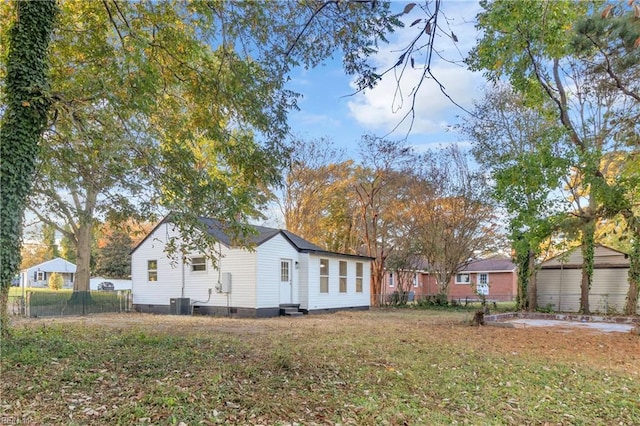 exterior space with a lawn and central AC unit