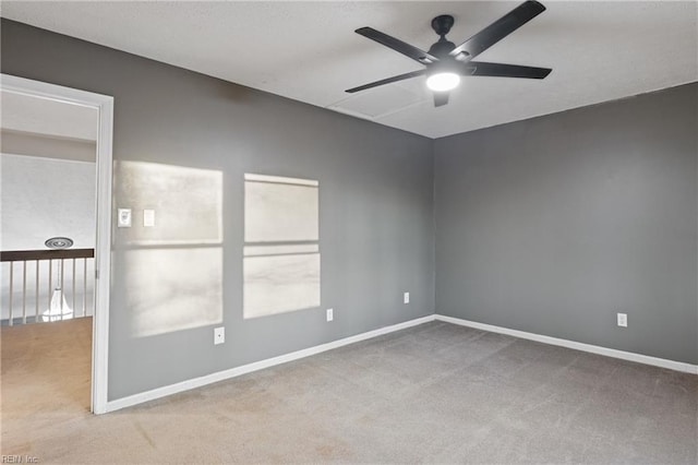 unfurnished room with ceiling fan and light colored carpet