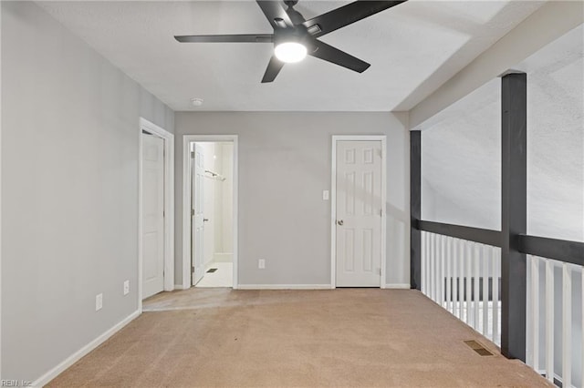 carpeted spare room with ceiling fan