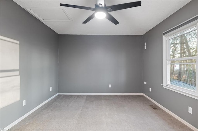 empty room with ceiling fan, plenty of natural light, and carpet floors