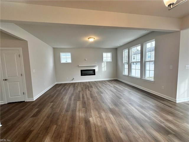 unfurnished living room with dark hardwood / wood-style floors