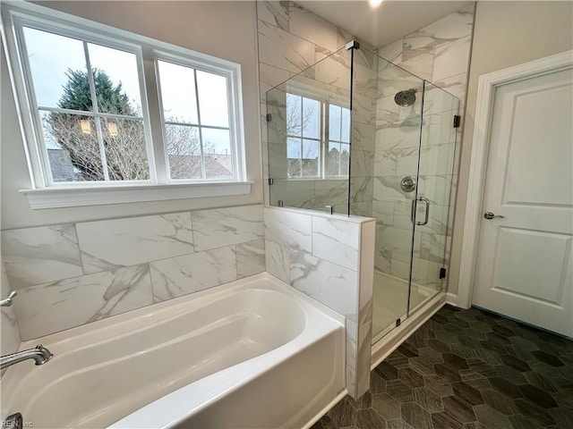 bathroom with separate shower and tub and tile patterned floors