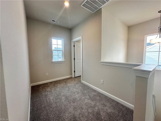 empty room featuring dark colored carpet