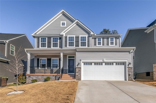 view of front facade featuring a garage, a front lawn, and a porch