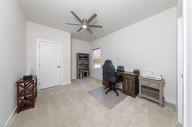 carpeted office space featuring ceiling fan