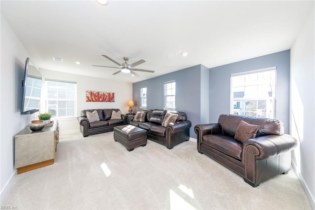 carpeted living room with ceiling fan