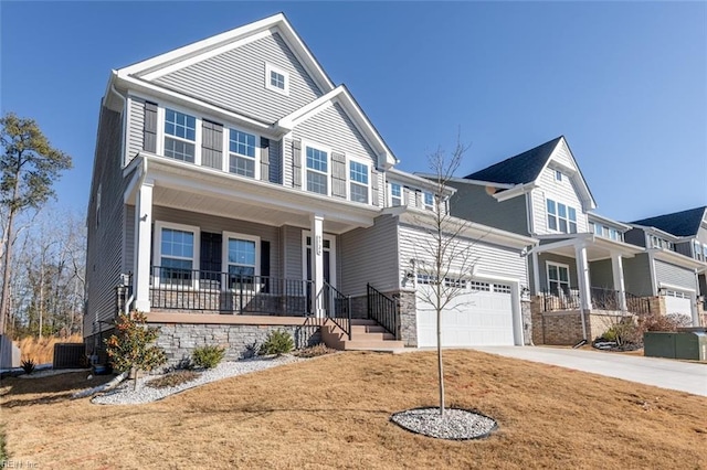 craftsman inspired home with a front lawn, cooling unit, a porch, and a garage