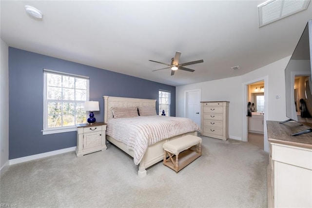 carpeted bedroom featuring ceiling fan and connected bathroom