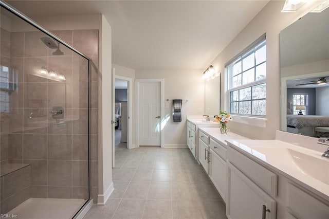 bathroom with ceiling fan, vanity, an enclosed shower, and tile patterned floors