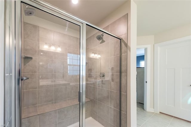 bathroom featuring an enclosed shower and tile patterned flooring