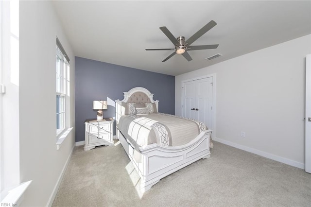 bedroom featuring light carpet and ceiling fan