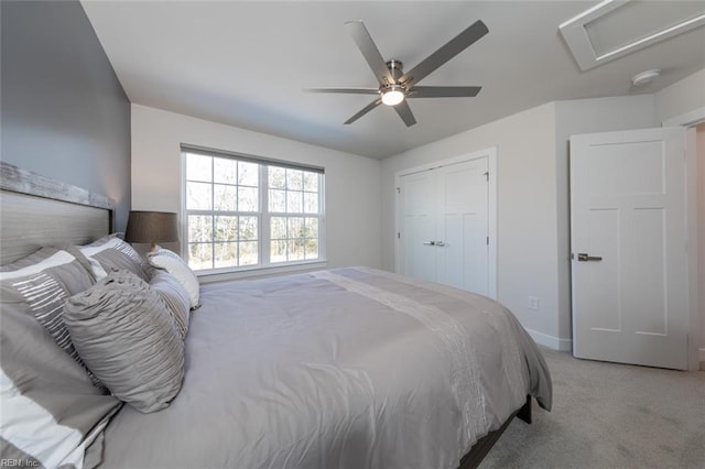 carpeted bedroom featuring ceiling fan and a closet