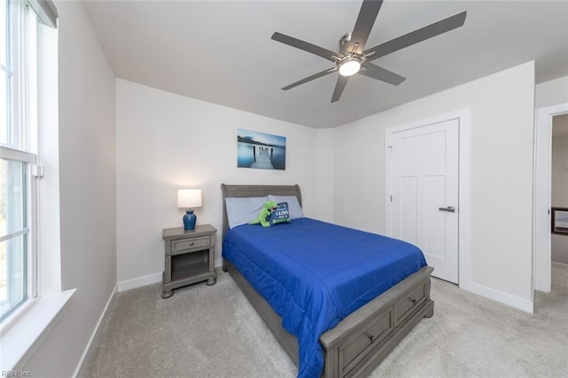 bedroom with light carpet and ceiling fan