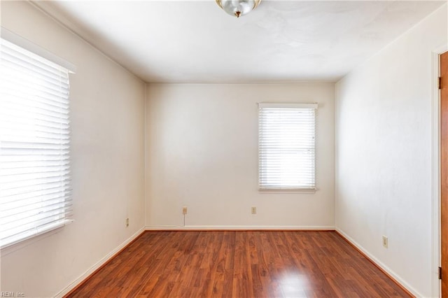 unfurnished room featuring dark hardwood / wood-style flooring