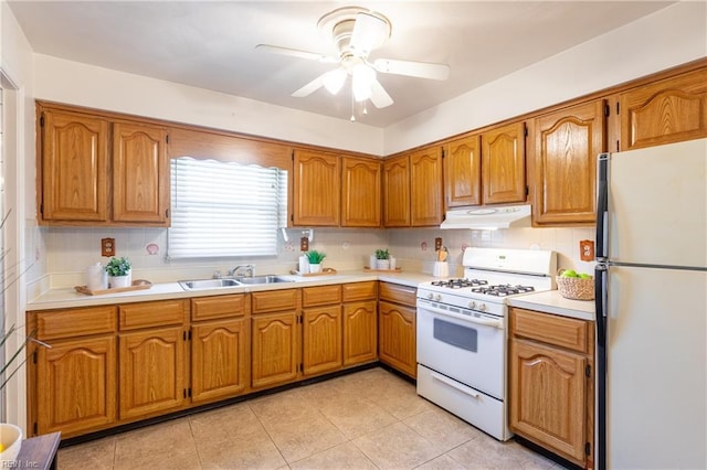 kitchen featuring white appliances, light tile patterned floors, decorative backsplash, ceiling fan, and sink