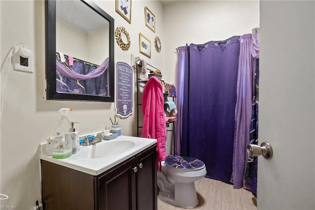 bathroom with toilet and vanity