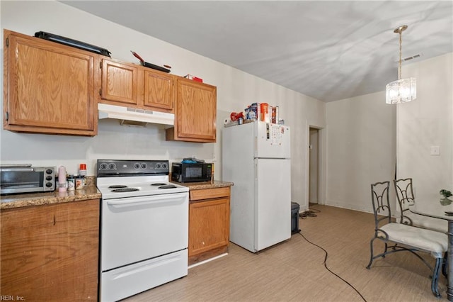 kitchen featuring pendant lighting, light stone countertops, white appliances, and a notable chandelier