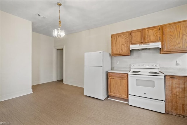 kitchen featuring white appliances, light wood-type flooring, a chandelier, and hanging light fixtures