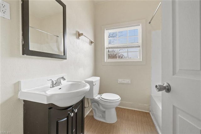 full bathroom featuring toilet, vanity, bathtub / shower combination, and hardwood / wood-style flooring