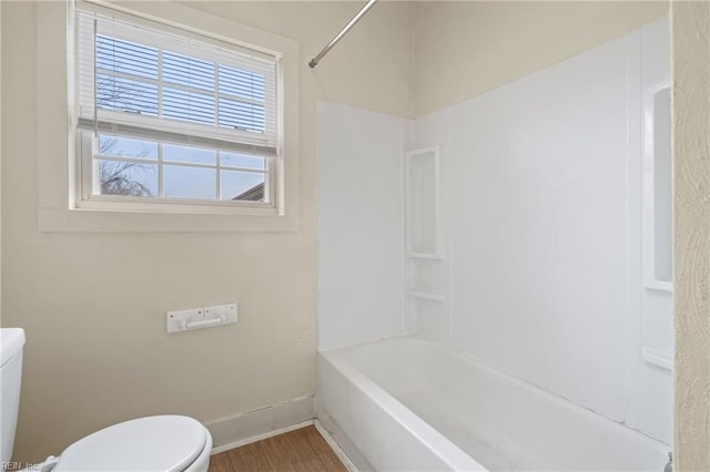 bathroom featuring toilet and bathtub / shower combination