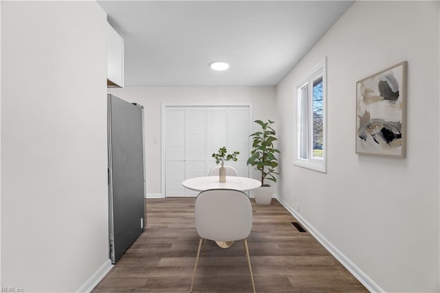 dining area featuring dark hardwood / wood-style flooring