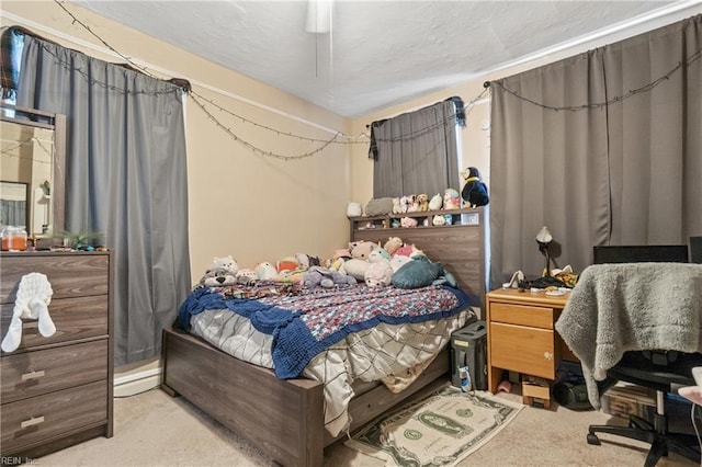 bedroom featuring light carpet and ceiling fan