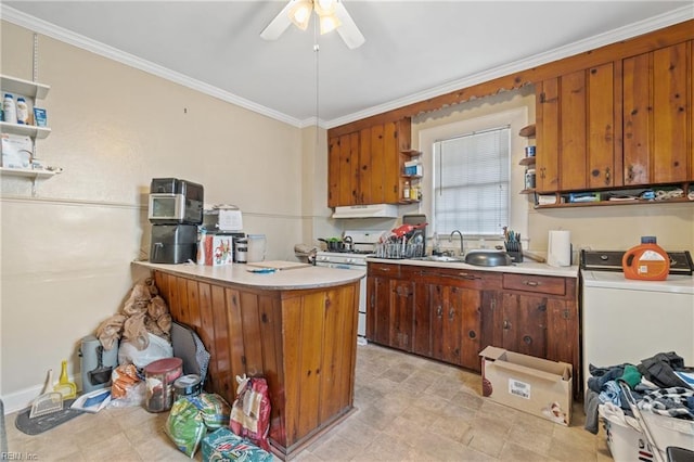 kitchen featuring ceiling fan, washer / dryer, gas range gas stove, sink, and ornamental molding