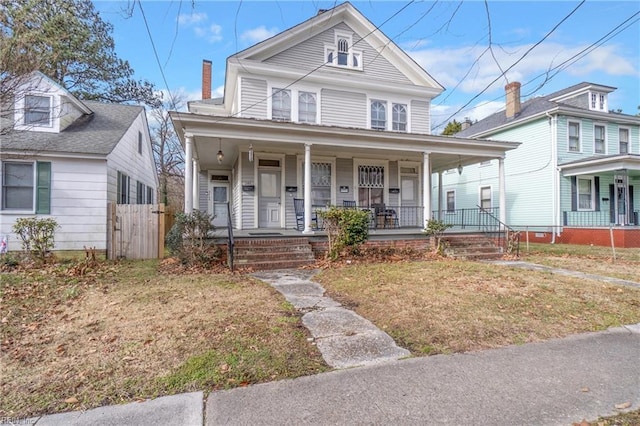 view of front facade featuring a front yard and covered porch