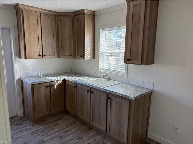 kitchen with dark hardwood / wood-style floors, sink, and a textured ceiling