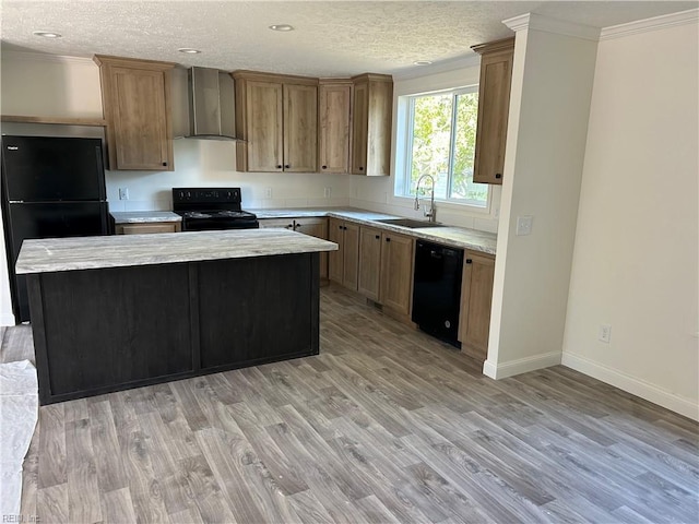 kitchen featuring wall chimney range hood, sink, a kitchen island, and black appliances