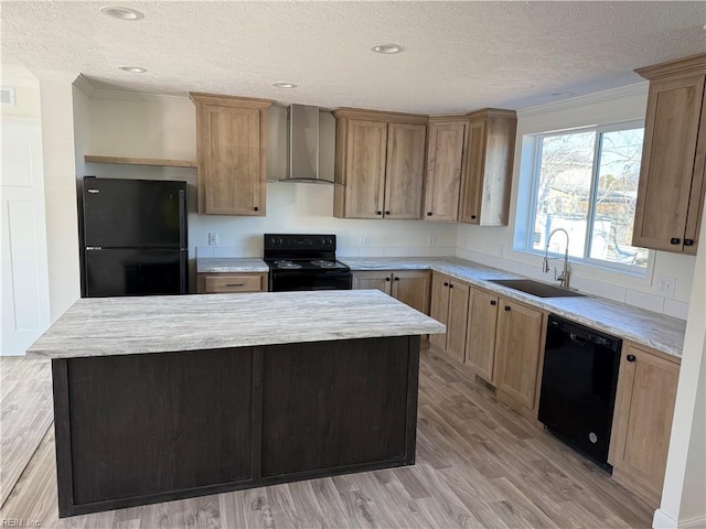 kitchen featuring sink, wall chimney range hood, black appliances, and a kitchen island