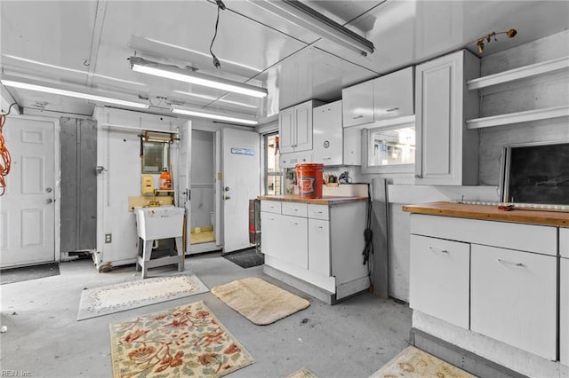 kitchen featuring sink and white cabinetry