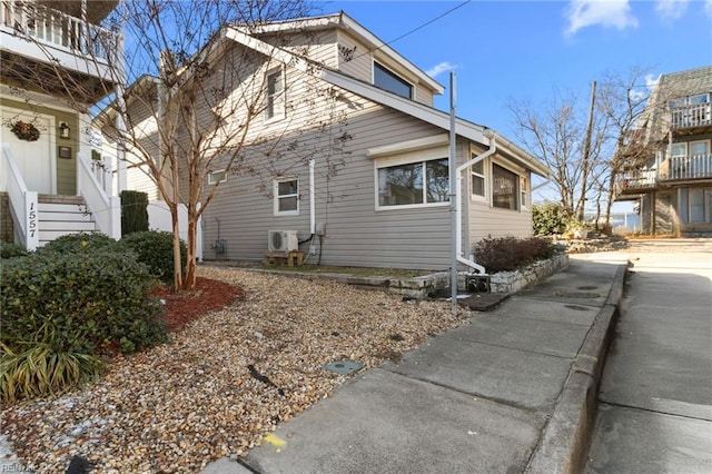 view of side of home featuring ac unit