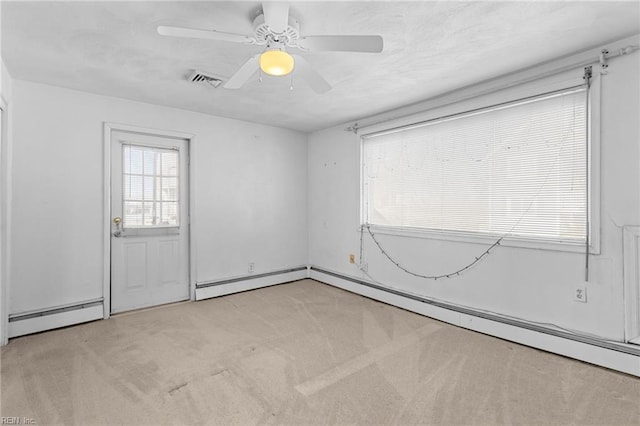 unfurnished room featuring ceiling fan, a baseboard radiator, and light carpet