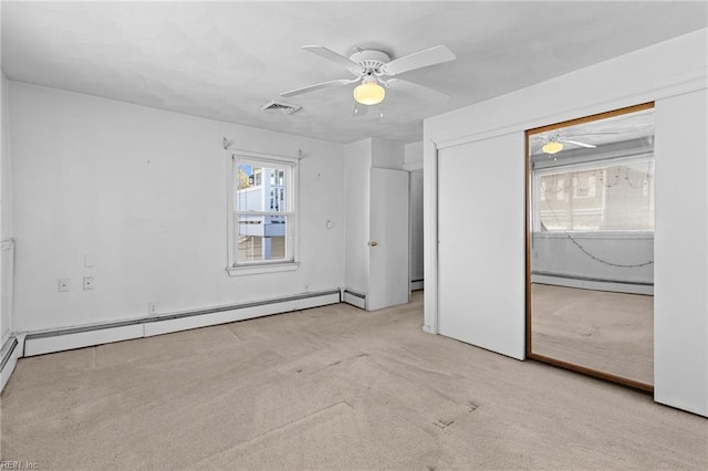 unfurnished bedroom with ceiling fan, a baseboard radiator, and multiple windows