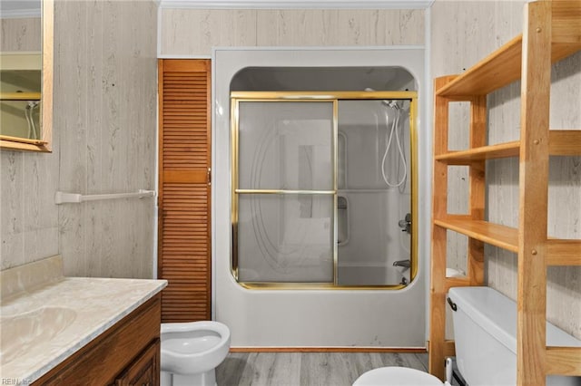 full bathroom with toilet, wood-type flooring, vanity, and enclosed tub / shower combo