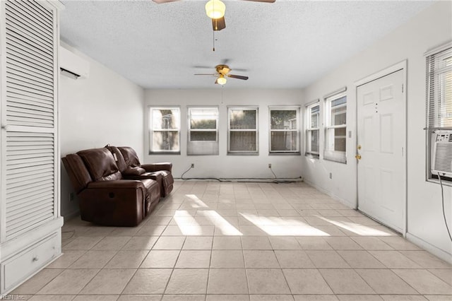 sunroom / solarium with a wall unit AC and ceiling fan