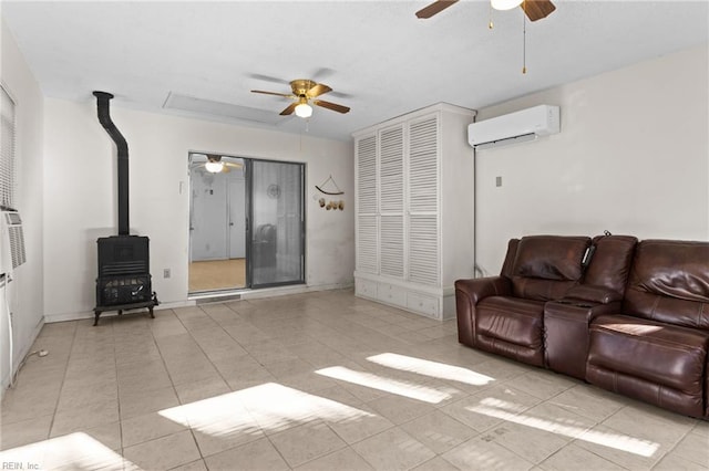 living room with ceiling fan, a wood stove, and a wall mounted air conditioner