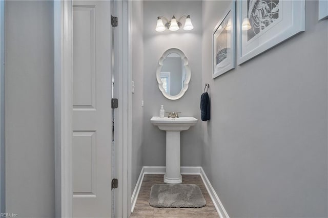 bathroom with wood-type flooring and decorative columns