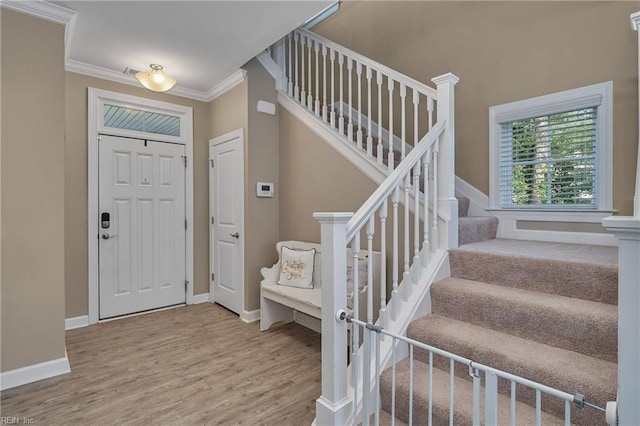 entrance foyer featuring ornamental molding and hardwood / wood-style flooring