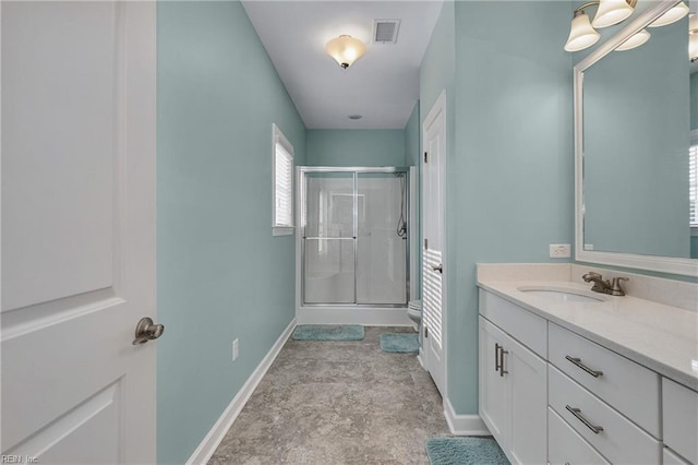 bathroom with a shower with door and vanity