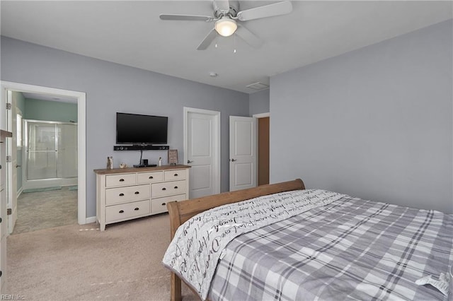 bedroom featuring ensuite bathroom, light carpet, and ceiling fan