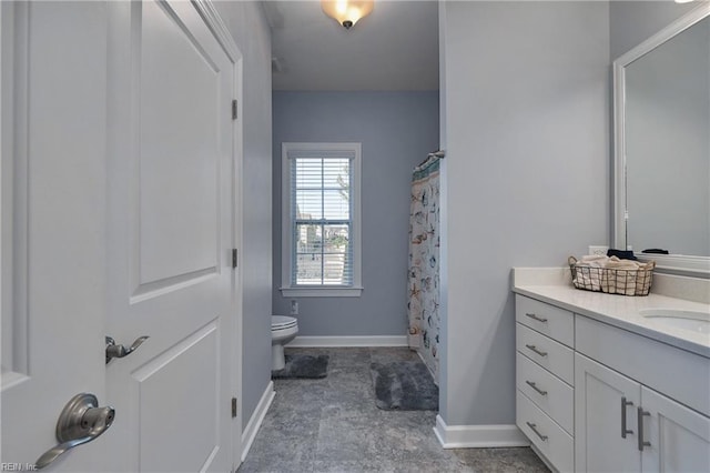 bathroom featuring toilet, vanity, and curtained shower