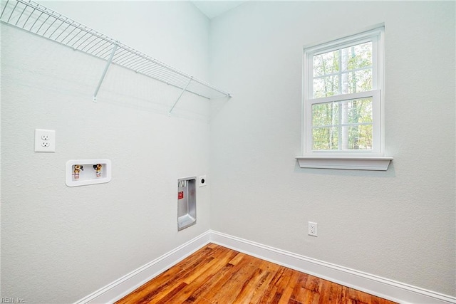 laundry room with laundry area, baseboards, wood finished floors, hookup for an electric dryer, and washer hookup