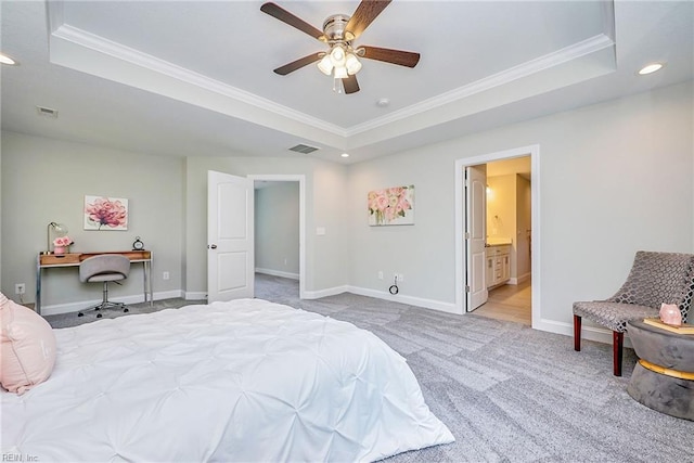 bedroom featuring carpet floors, visible vents, a tray ceiling, and baseboards