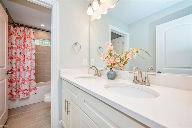 bathroom with toilet, double vanity, a sink, and shower / tub combo with curtain