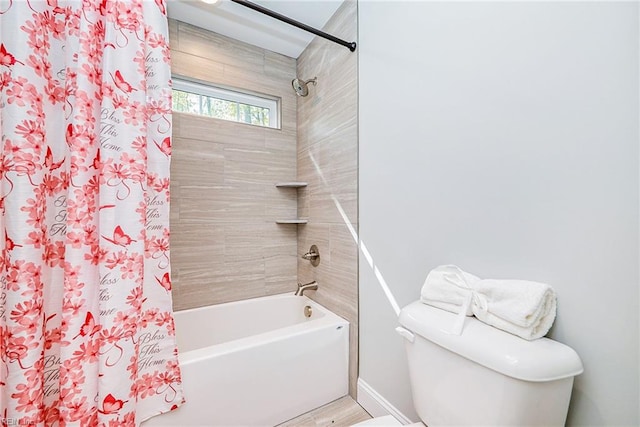 bathroom with shower / bathtub combination with curtain and toilet