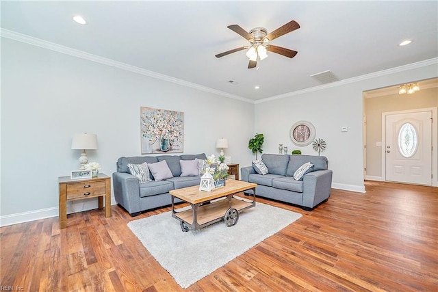 living area with ornamental molding, recessed lighting, light wood-style flooring, and baseboards